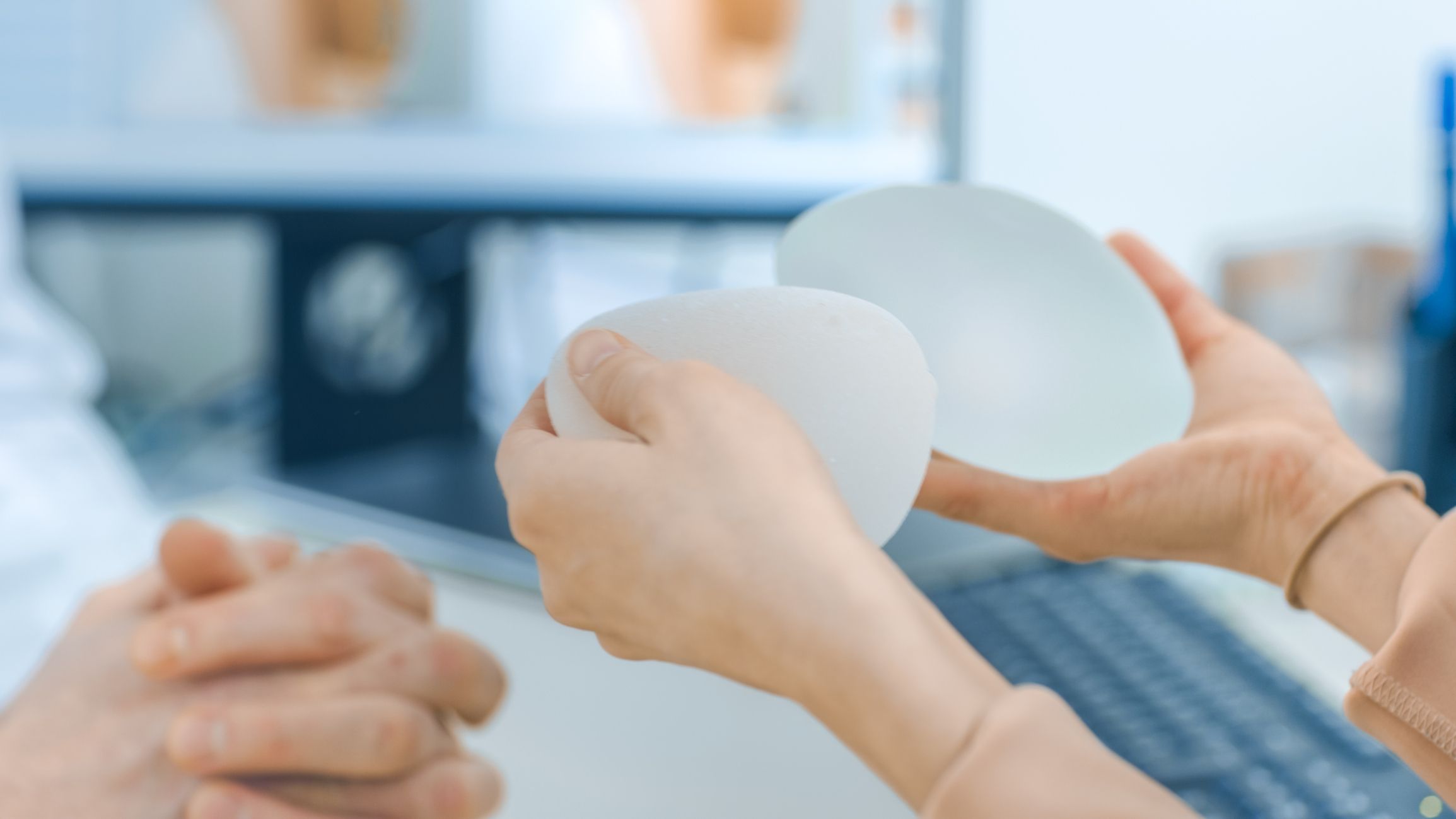 Cosmetic Surgeon Shows Female Patient Breast Implant Samples