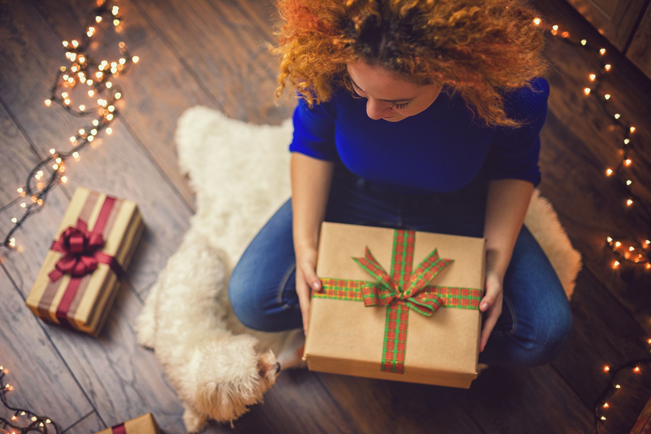 Girl With Present in a Cozy Christmas Atmosphere