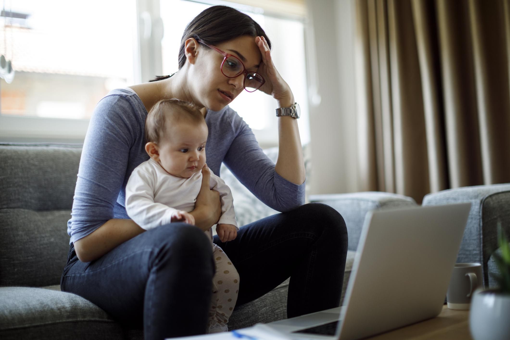 Tired young mother working from home