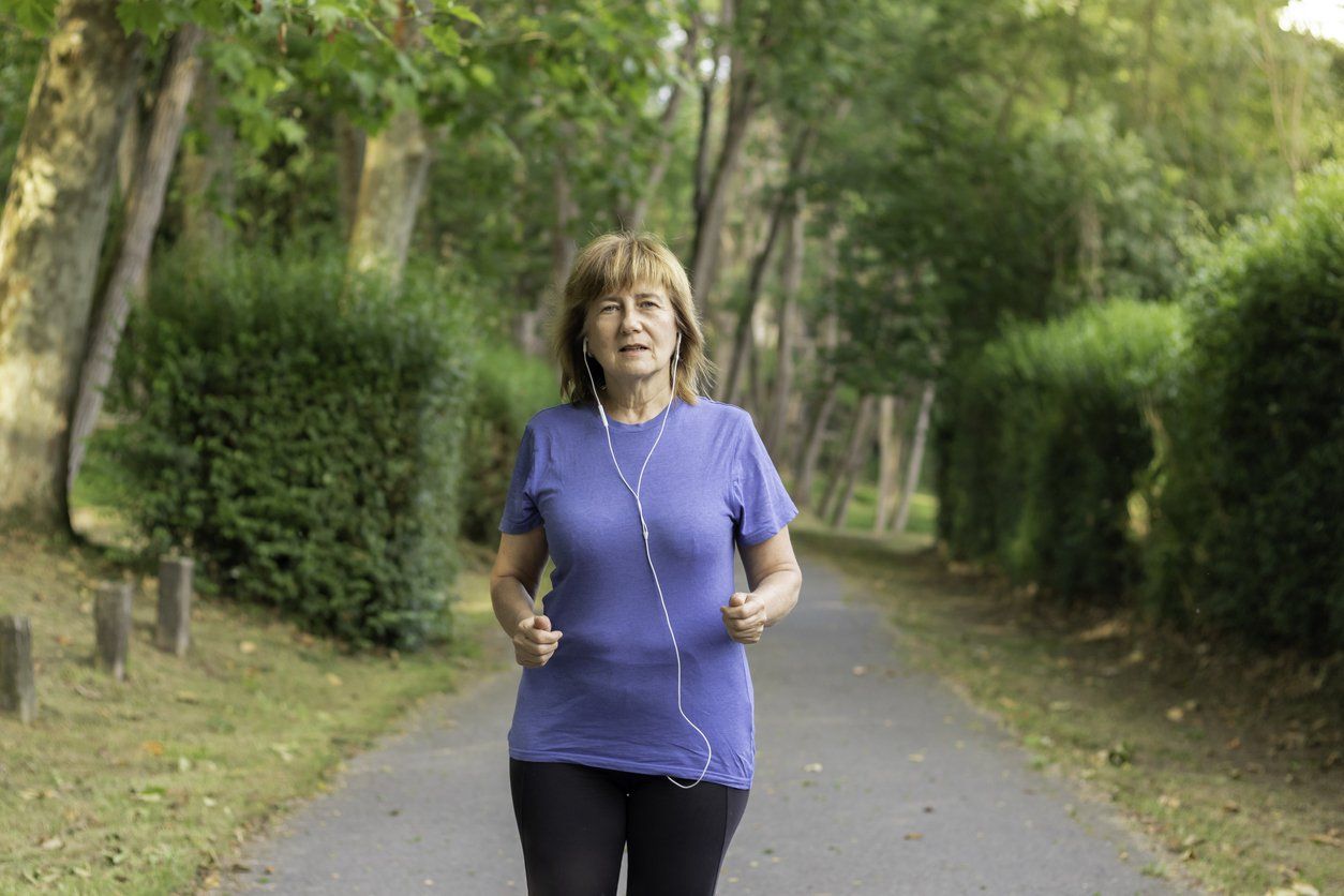 older woman walking outdoors