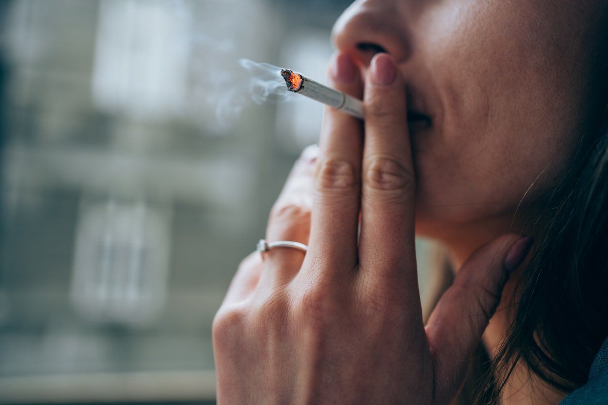 woman smoking a cigarette outdoors