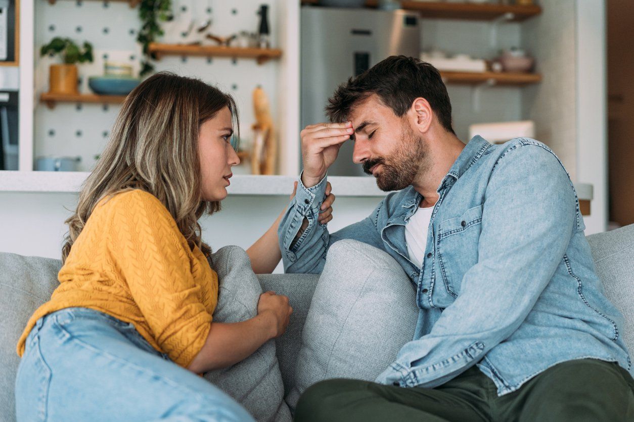 young wife expressing empathy and compassion to her sad frustrated husband.