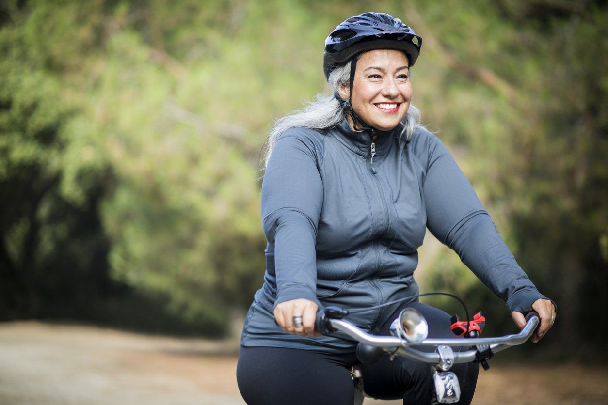 woman biking to burn 200 calories in an hour