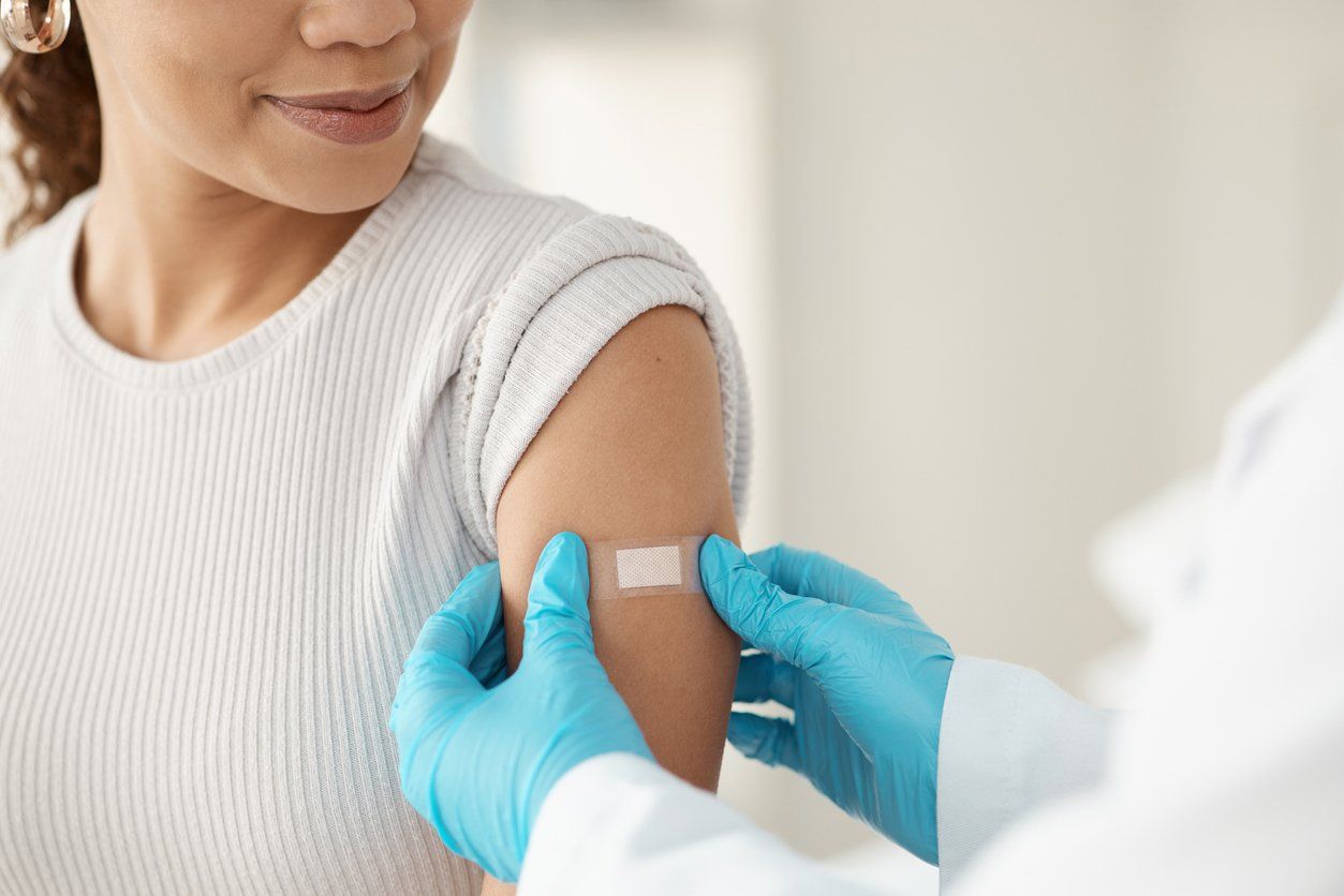 doctor applying a band-aid after getting a vaccination