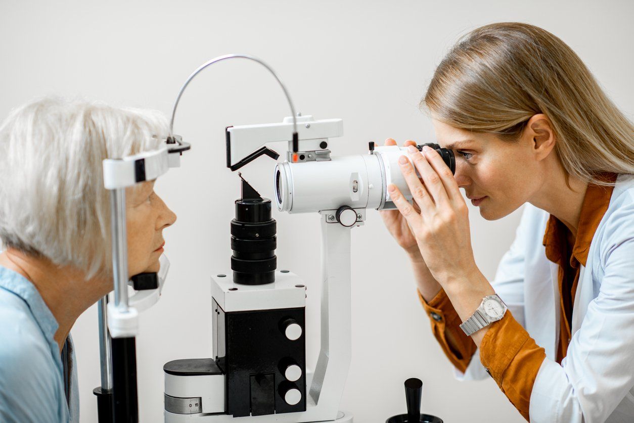 Ophthalmologist examining eyes with a microscope