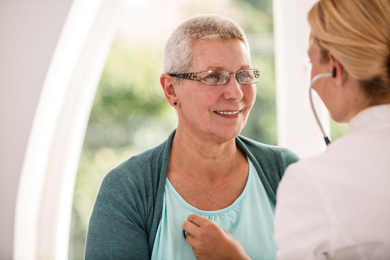 senior woman receiving medical examination at doctor's office.