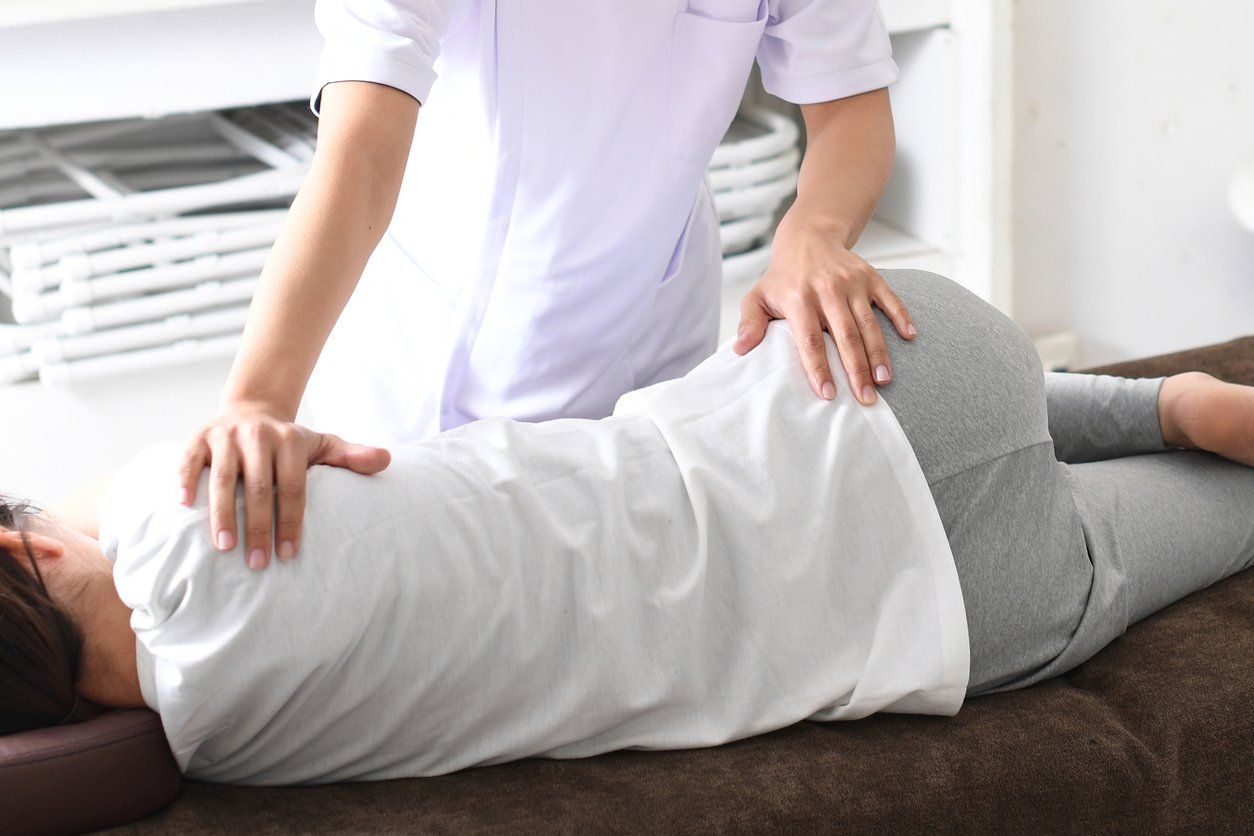 medical worker and a female patient performing pelvic correction surgery