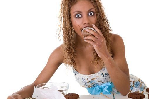 woman eating a cupcake