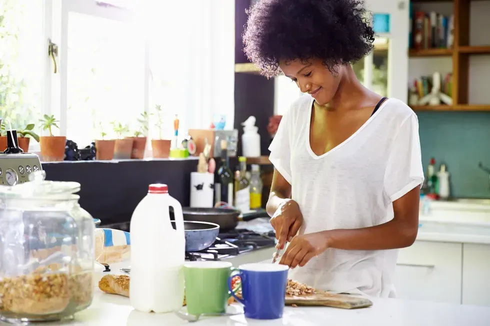 Woman Wearing Pajamas Preparing Breakfast In Kitchen