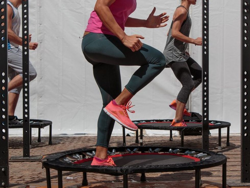 Mini Trampoline Workout: Girl doing Fitness Exercise in Class