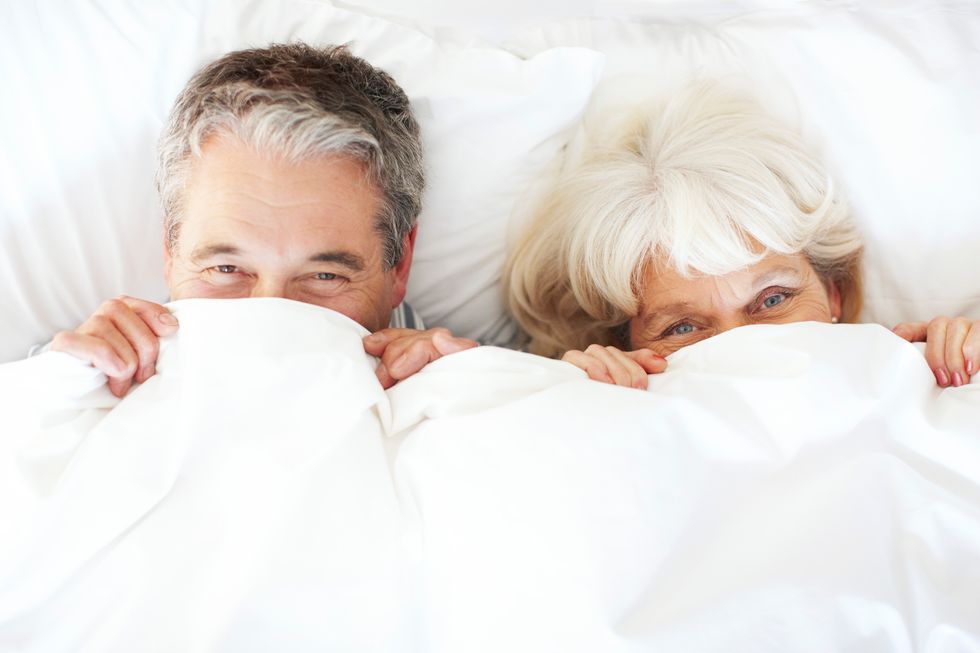 older couple Playing under the covers