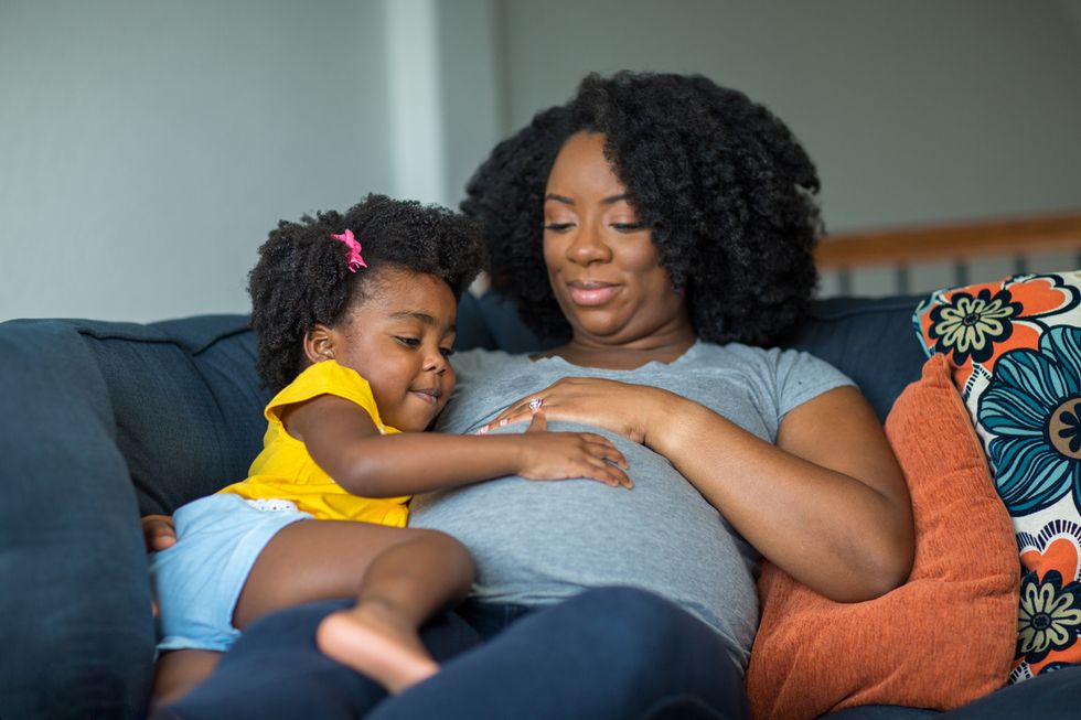 pregnant mother and her daughter.