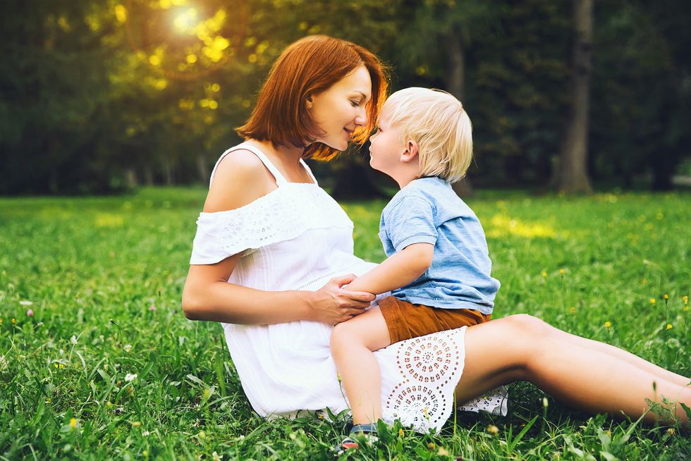 Pregnant woman with toddler kid outdoors