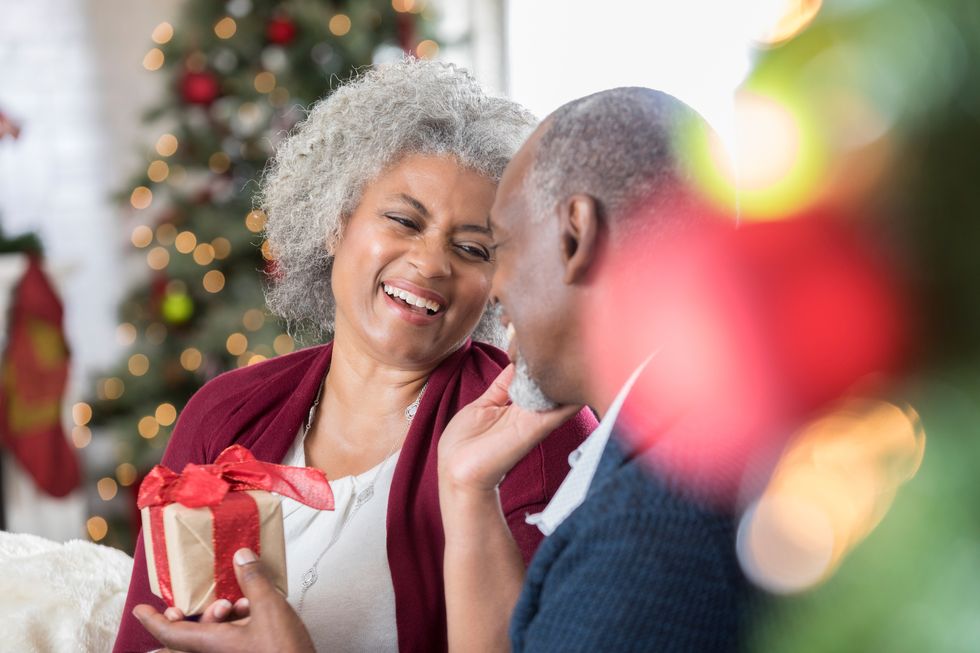 senior woman receives Christmas present from husband