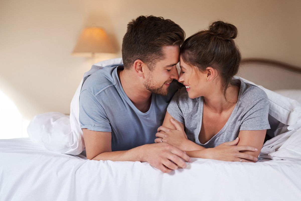 smiling couple in bed, helping Him Last Longer
