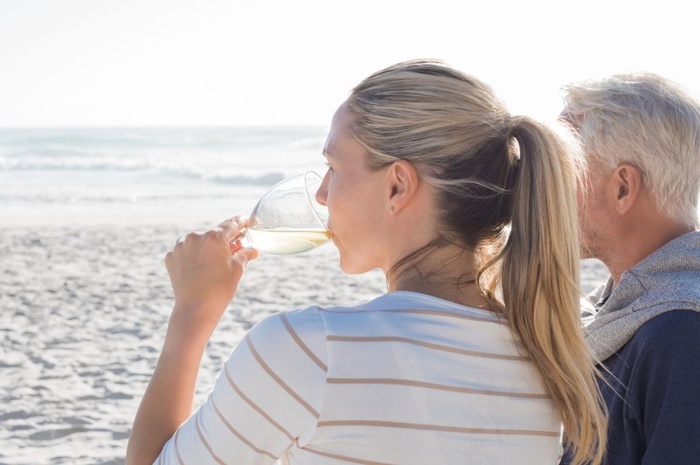 woman drinking white wine at seaside