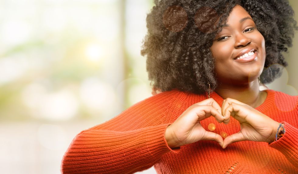 woman happy showing love with hands in heart shape