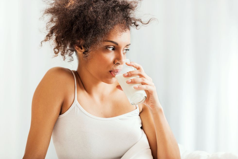 woman in bed drinking milk.